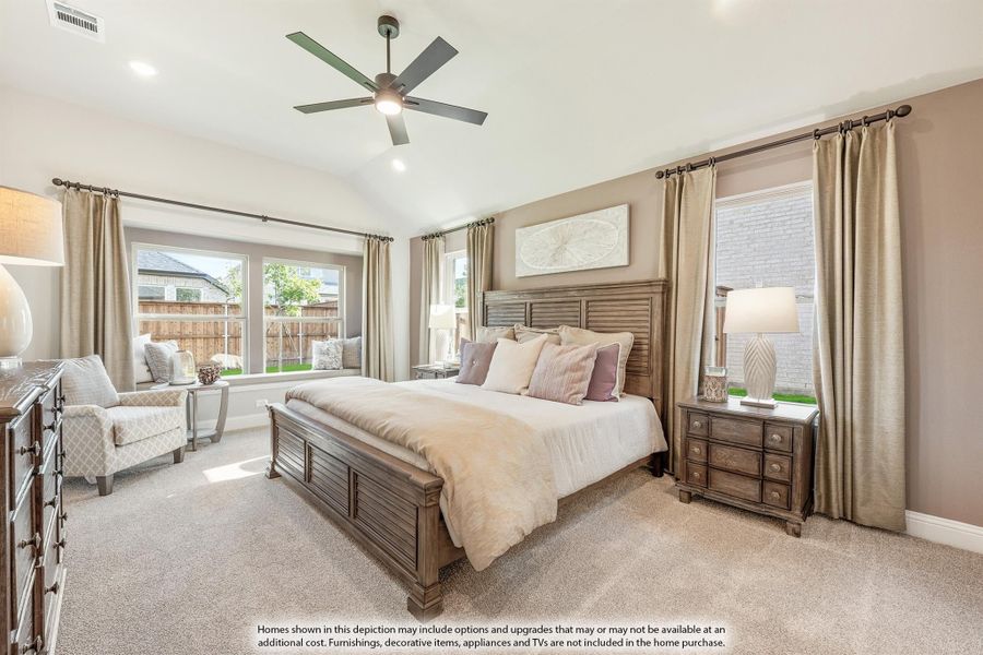 Spacious master bedroom with wood bed frame, ceiling fan, carpet flooring, and large windows with neutral drapes. Spacious master bedroom with wood bed frame, ceiling fan, carpet flooring, and large windows with neutral drapes.