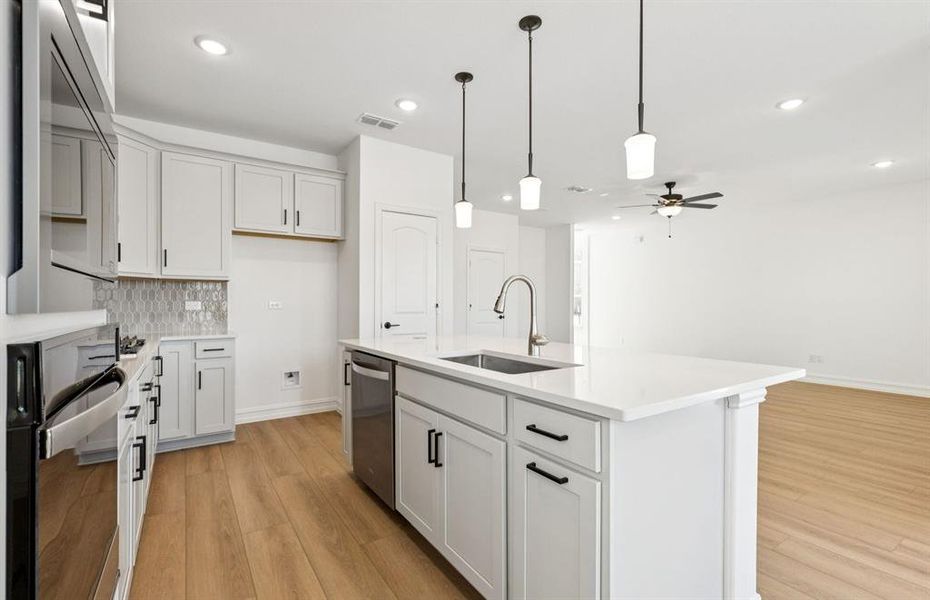 Large island overlooking gathering room and dining areas Large island overlooking gathering room and dining areas