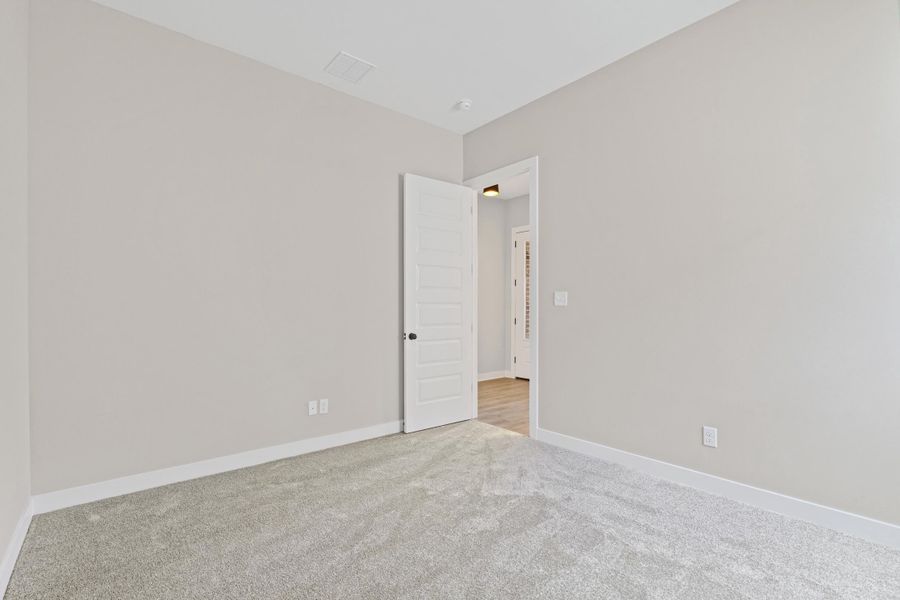 Neutral-toned walls complement the light gray carpet Neutral-toned walls complement the light gray carpet