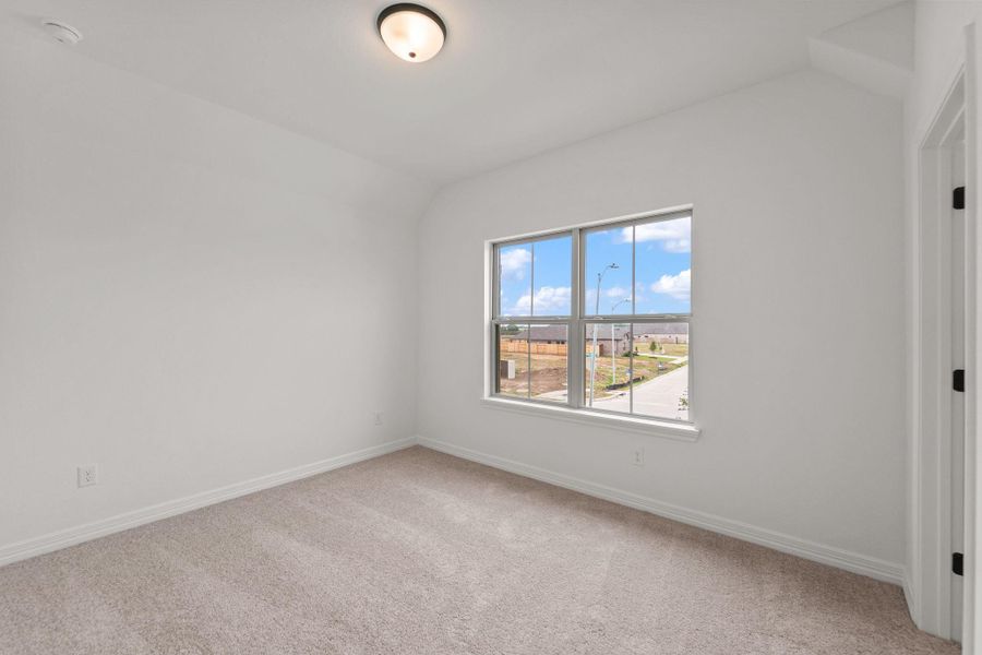 Your secondary bedroom features plush carpet, fresh paint, closet, and a large window that lets in plenty of natural lighting.