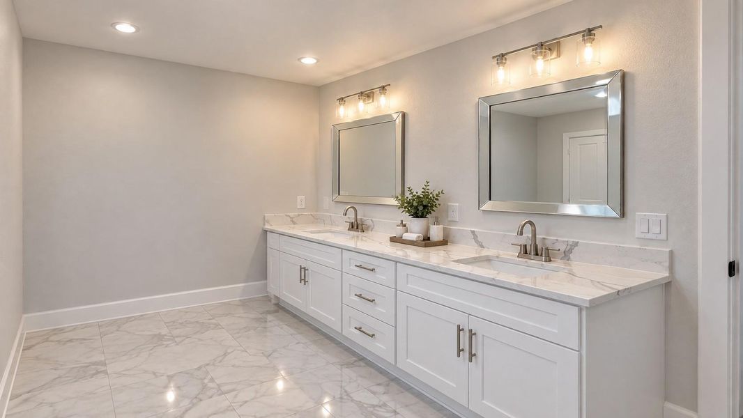 Elegant bathroom featuring a spacious double vanity with beautiful quartz countertops, contemporary fixtures, and stylish lighting, all set against a polished tile flooring.