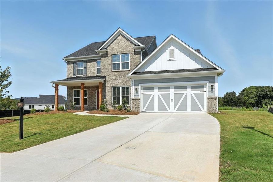 Front exterior of a new home in Berkeley Mill, Cumming, GA, highlighting curb appeal (Image 2). Front exterior of a new home in Berkeley Mill, Cumming, GA, highlighting curb appeal (Image 2).