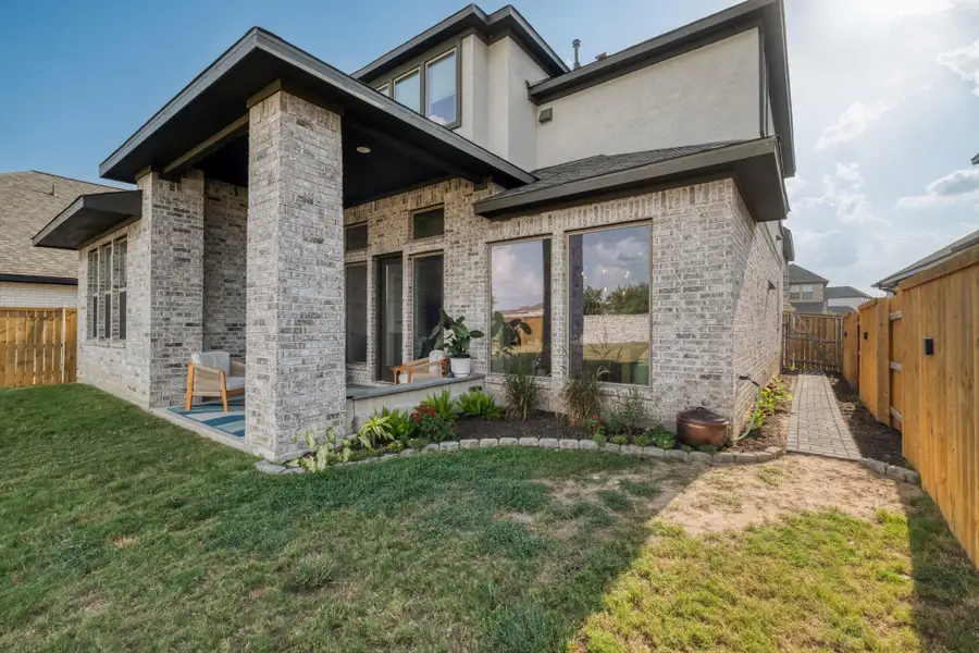 Oversized windows connect the main living spaces to the backyard.