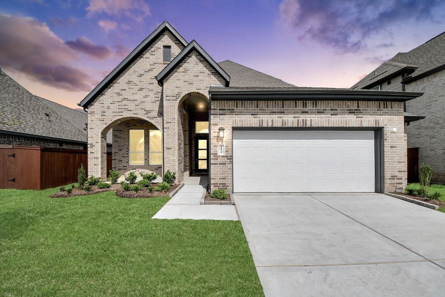 Front exterior of a new home in Meridiana 50's, Manvel, TX, highlighting curb appeal (Image 24).