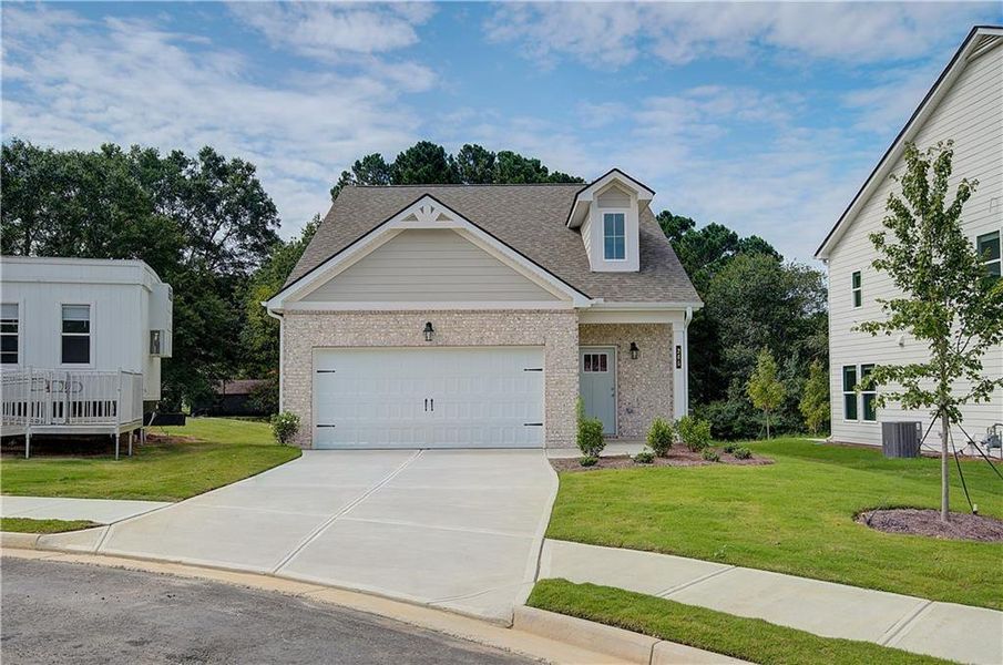 Front exterior of a new home in Abbotts Crossing, Conyers, GA, highlighting curb appeal (Image 1).
