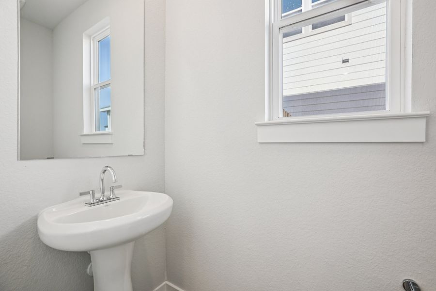 A bathroom with a sink and a window.