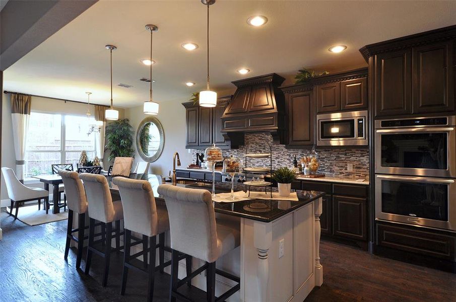 Large island overlooking gathering room and dining areas Large island overlooking gathering room and dining areas