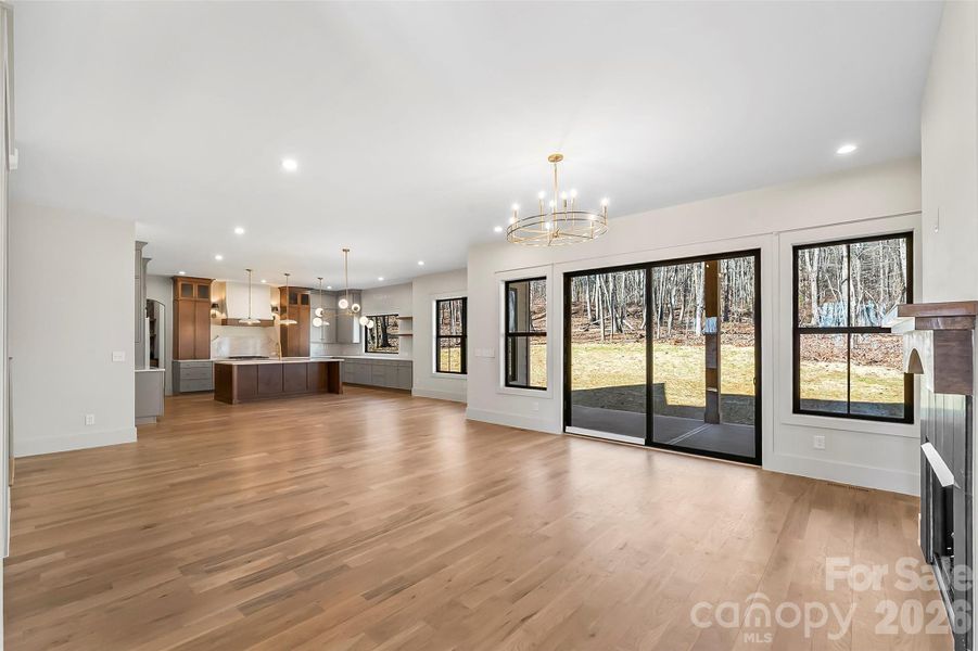 Natural light warms this space and sliding doors lead to the wooded backyard.
