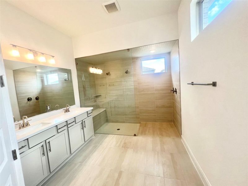 Full bathroom featuring double vanity and a walk in shower Full bathroom featuring double vanity and a walk in shower