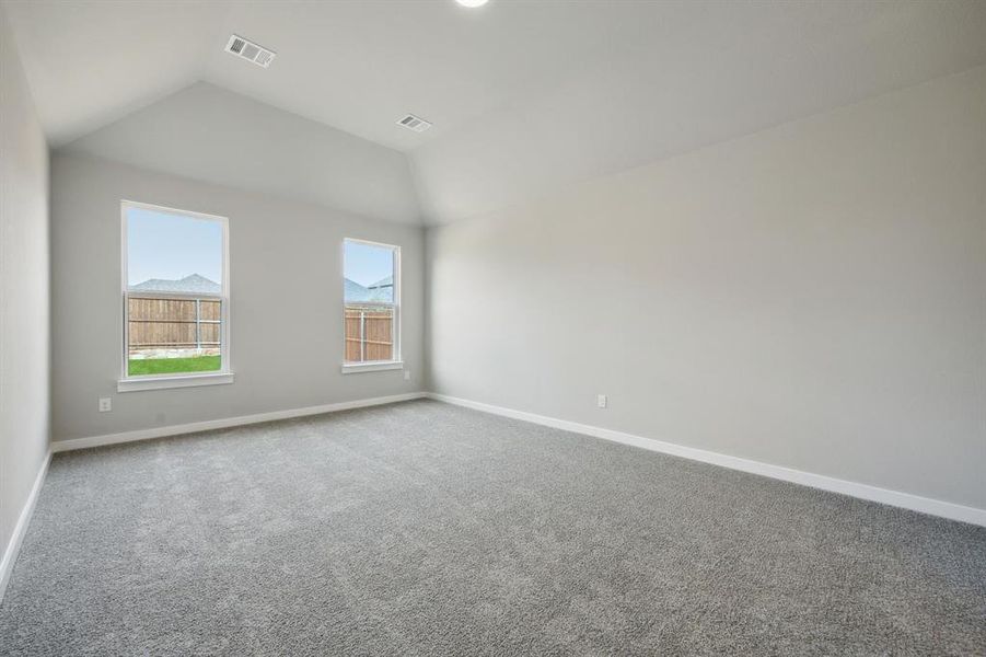 The primary bedroom is at the back of the home with great views of the back yard