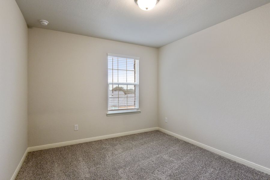 Guest bedroom in the Red River floorplan at a Meritage Homes community.