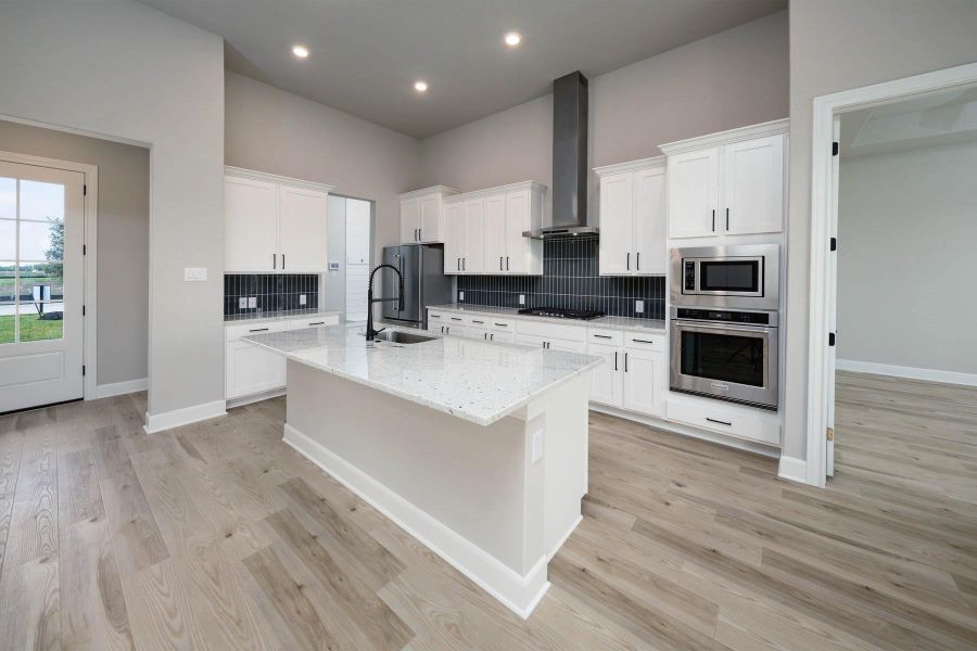 With an open layout, the kitchen island becomes the focal point, offering a spacious and inviting atmosphere that encourages family members to gather, chat, and enjoy each other's company while meals are prepared. With an open layout, the kitchen island becomes the focal point, offering a spacious and inviting atmosphere that encourages family members to gather, chat, and enjoy each other's company while meals are prepared.