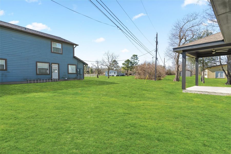 Open backyard with plenty of room for gardening, play, or entertaining. Fenced-in area offers privacy and security.