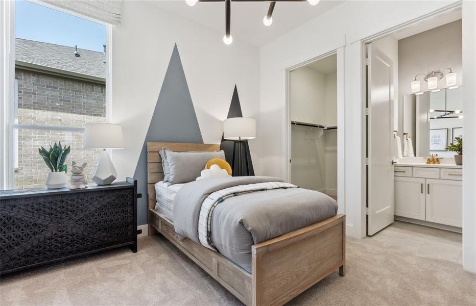 Comfortable secondary bedroom with generous closet space  *Real home pictured