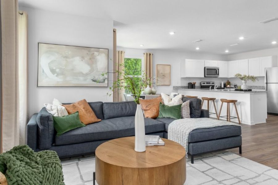 A living room with a couch and coffee table. A living room with a couch and coffee table.