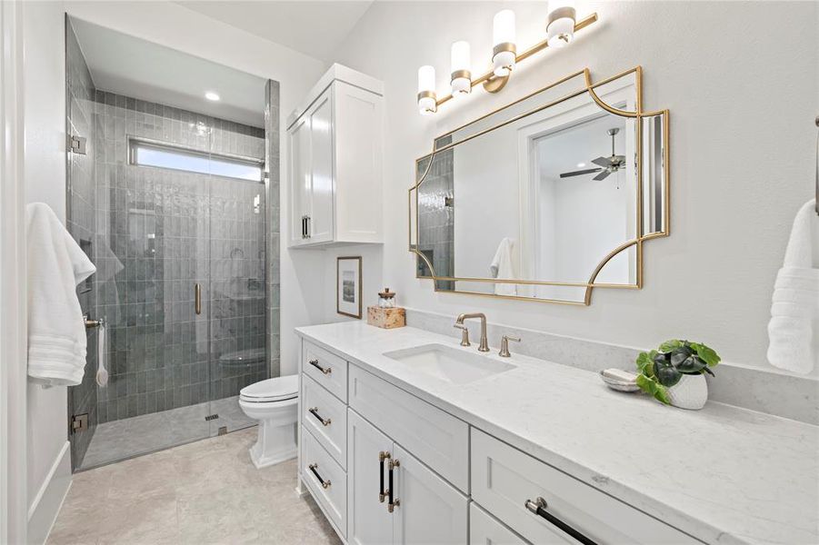 Full bathroom with vanity and a stall shower