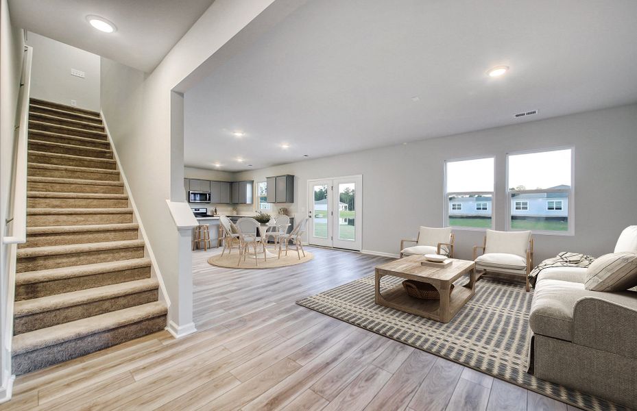 Spacious, open floorplan with hardwood floors and large windows.