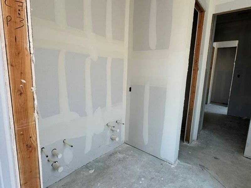 A new construction bathroom, poised for fixtures and finishes, reveals plumbing rough-ins. A new construction bathroom, poised for fixtures and finishes, reveals plumbing rough-ins.