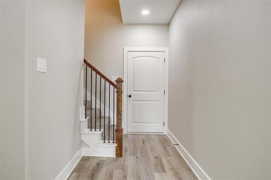 Staircase featuring hardwood / wood-style flooring