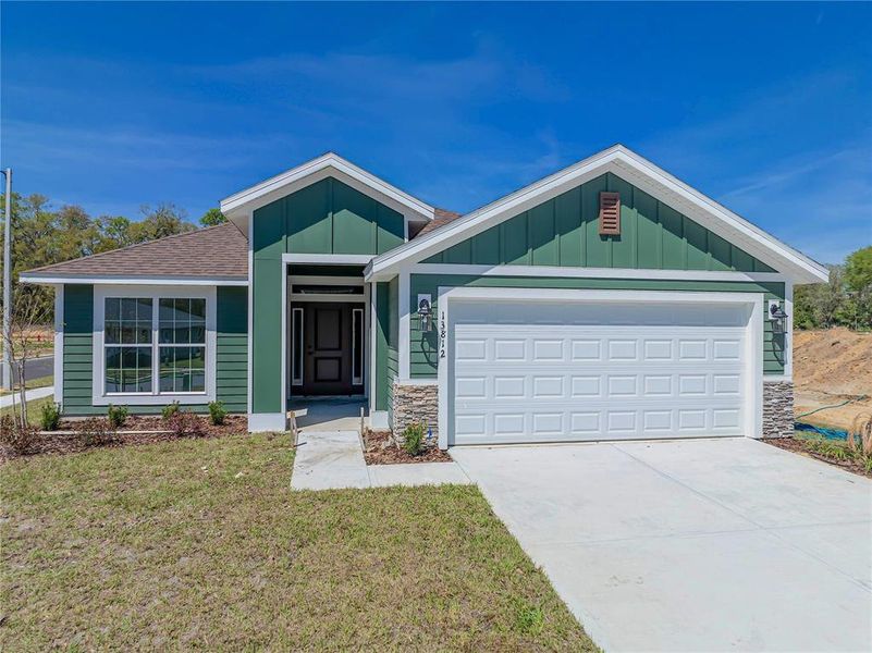 Front exterior of a new home in Briarwood, Alachua, FL, highlighting curb appeal (Image 17).