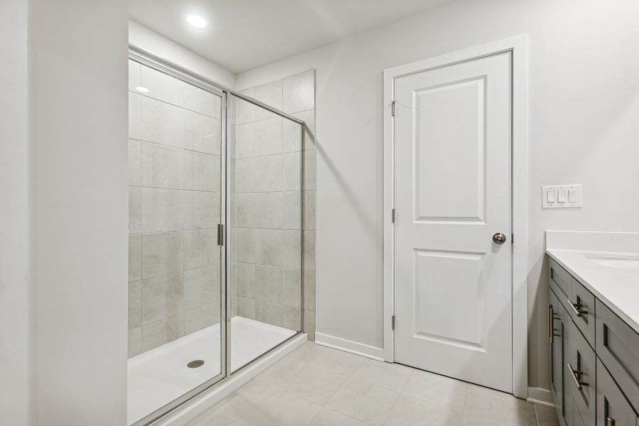 A bathroom with a glass shower. A bathroom with a glass shower.