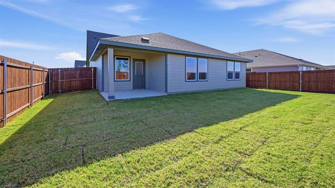 Back of house featuring a patio area, a shingled roof, and a fenced backyard Back of house featuring a patio area, a shingled roof, and a fenced backyard