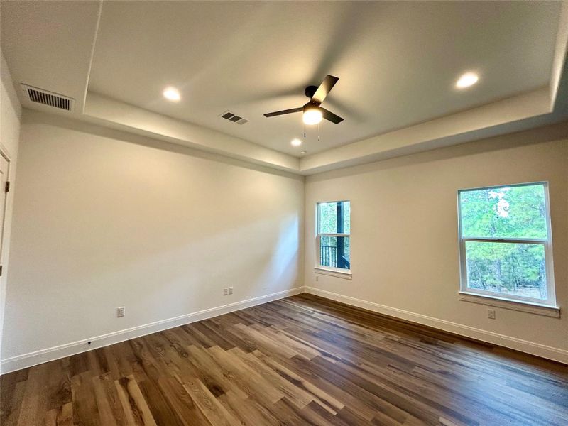 Primary bedroom with view of the pine trees. Primary bedroom with view of the pine trees.