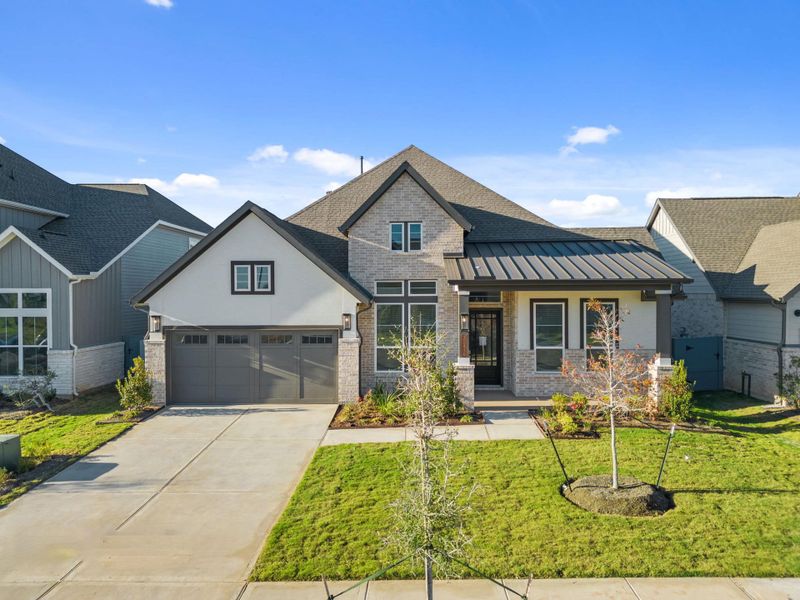 Front exterior of a new home in Fulshear Lakes, Fulshear, TX, highlighting curb appeal (Image 24). Front exterior of a new home in Fulshear Lakes, Fulshear, TX, highlighting curb appeal (Image 24).