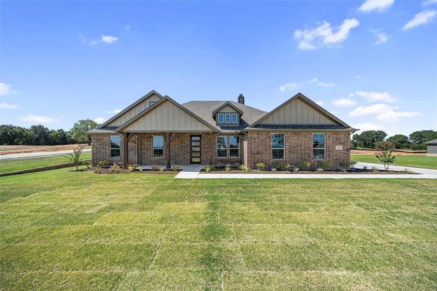 Front exterior of a new home in Oak Grove Addition, Springtown, TX, highlighting curb appeal (Image 2). Front exterior of a new home in Oak Grove Addition, Springtown, TX, highlighting curb appeal (Image 2).