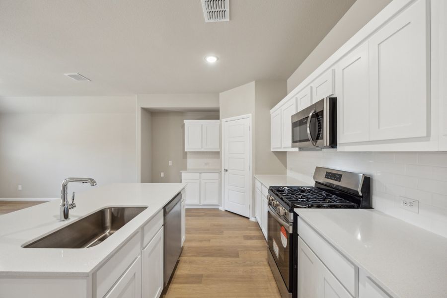 Kitchen in the Harper home plan by Trophy Signature Homes – REPRESENTATIVE PHOTO