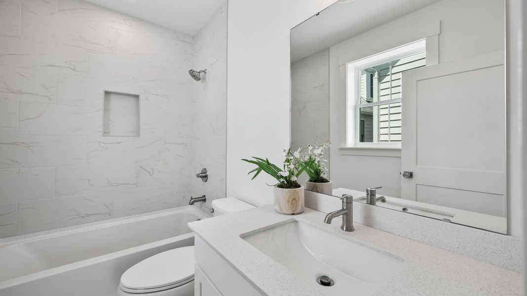 Secondary bathroom in the Sullivan home plan with modern fixtures and bright finishes.
