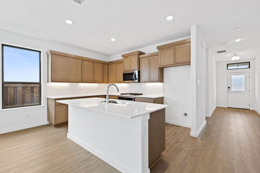 Kitchen in the Stanley II home plan by Trophy Signature Homes – REPRESENTATIVE PHOTO