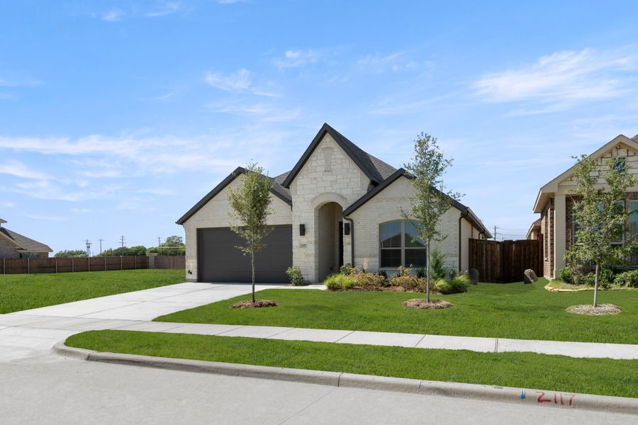 Front exterior of a new home in Somerset, Mansfield, TX, highlighting curb appeal (Image 2). Front exterior of a new home in Somerset, Mansfield, TX, highlighting curb appeal (Image 2).