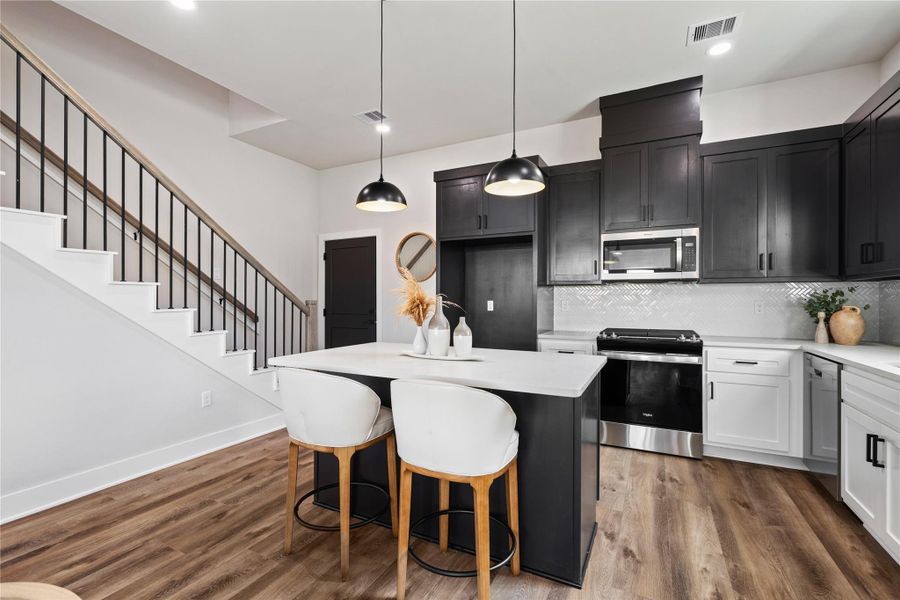 The dining and living areas flow together with a clean, open layout that feels both functional and elevated. With generous space and natural light throughout, this home is built to feel comfortable, welcoming, and easy to enjoy.