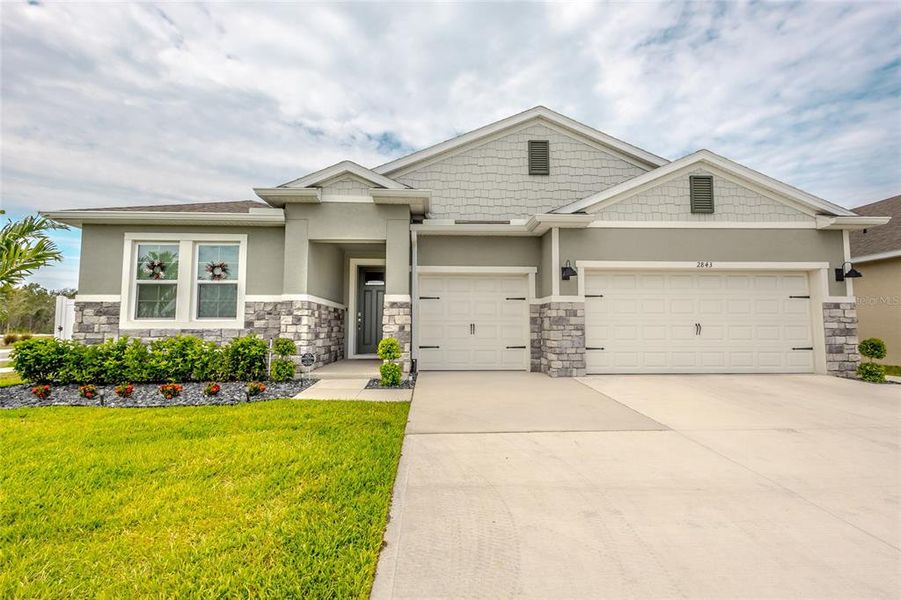 Front exterior of a new home in Harmony West, Harmony, FL, highlighting curb appeal (Image 1). Front exterior of a new home in Harmony West, Harmony, FL, highlighting curb appeal (Image 1).
