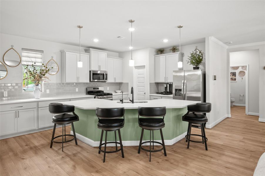Large kitchen with abundant cabinetry and an expansive breakfast bar