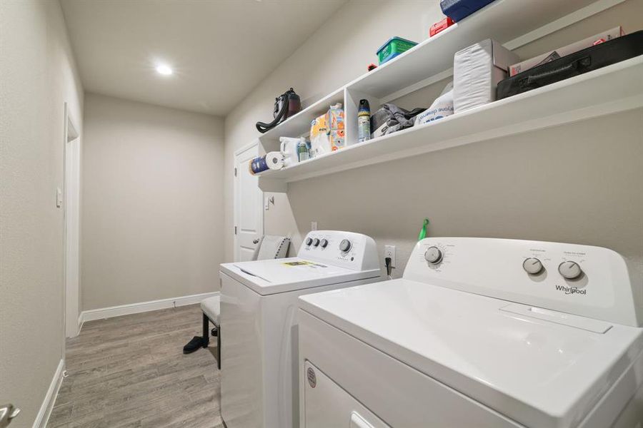 Laundry area featuring light wood-type flooring, separate washer and dryer, and recessed lighting Laundry area featuring light wood-type flooring, separate washer and dryer, and recessed lighting