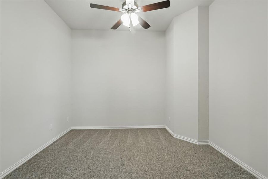 Spare room featuring carpet floors and ceiling fan