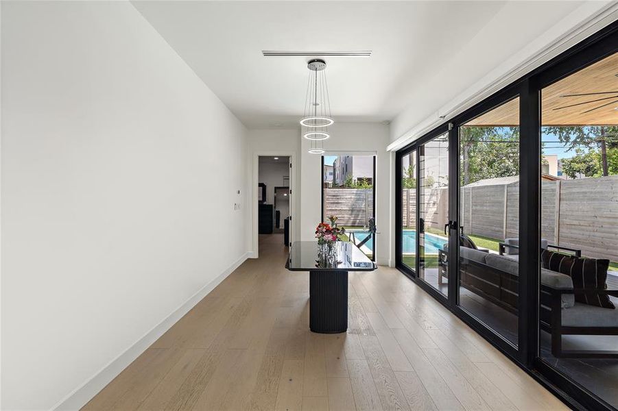 Dining room with natural light and custom electric blinds.