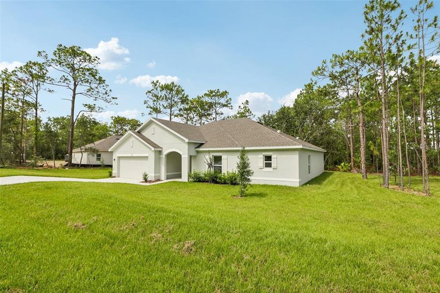 Front exterior of a new home in Sugarmill Woods, Homosassa, FL, highlighting curb appeal (Image 8).