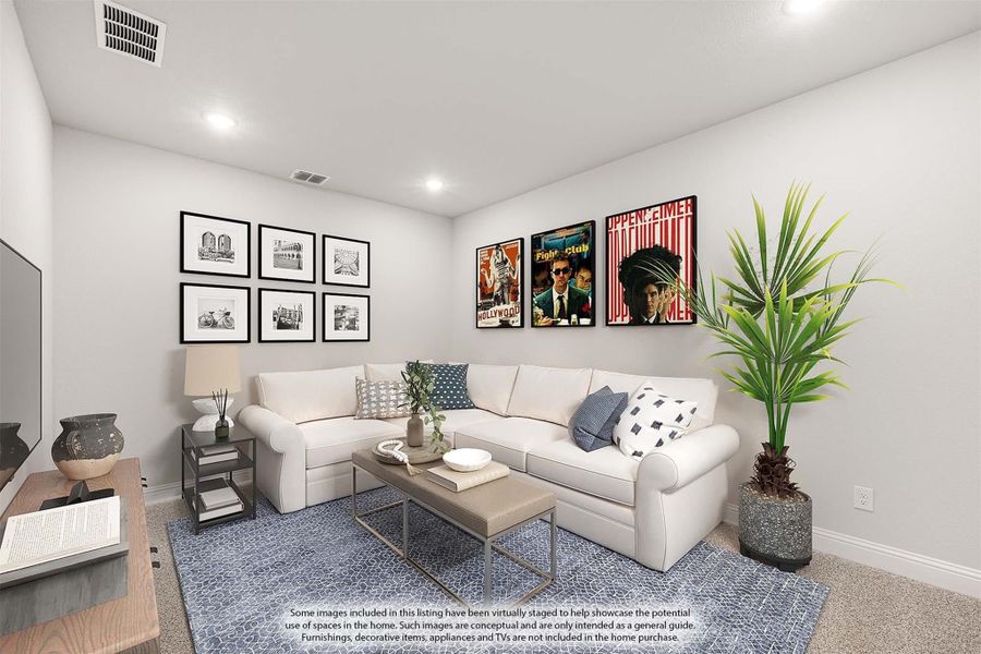 Living room with white sectional sofa, blue area rug, framed wall art, and a large potted plant