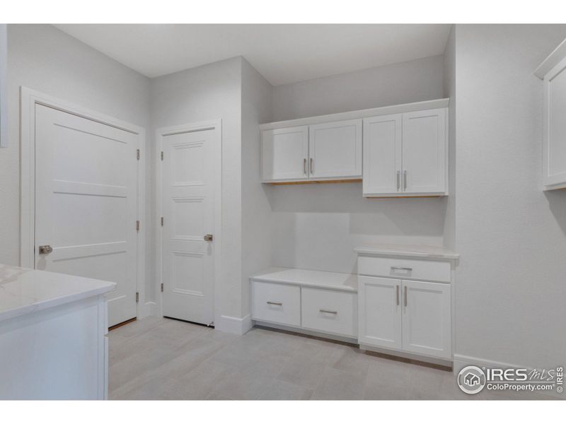 A convenient "drop-zone" mudroom right off the garage, with plenty of storage & a coat closet