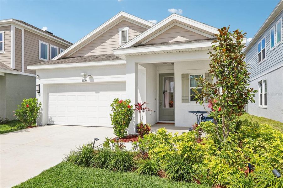 Front exterior of a new home in Waterset Garden Series, Apollo Beach, FL, highlighting curb appeal (Image 28).