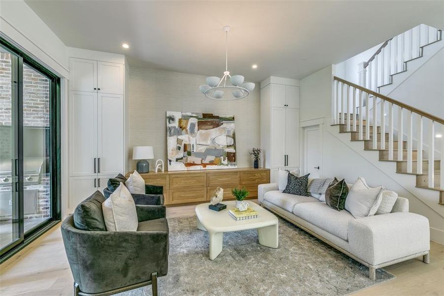 Living room featuring light hardwood / wood-style floors and a chandelier