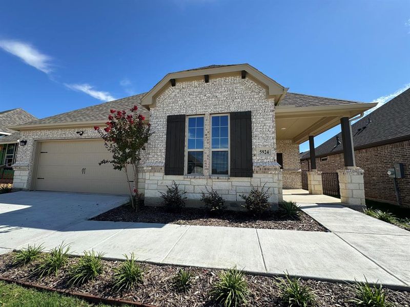 Front exterior of a new home in Ladera Tavolo Park, Fort Worth, TX, highlighting curb appeal (Image 2). Front exterior of a new home in Ladera Tavolo Park, Fort Worth, TX, highlighting curb appeal (Image 2).
