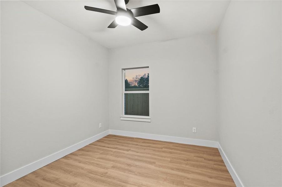 Unfurnished room featuring ceiling fan and light hardwood / wood-style flooring