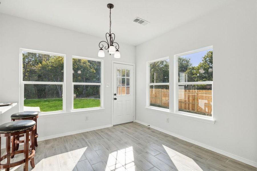 Dining area and entry to spacious back yard