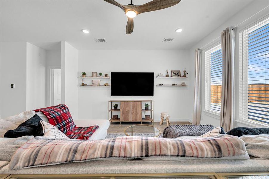 Living room featuring hardwood / wood-style floors and ceiling fan