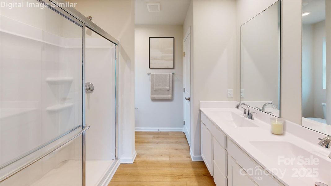 Relax in the elegant owner's bath, complete with a spacious walk-in shower and dual vanities—designed for comfort and style.