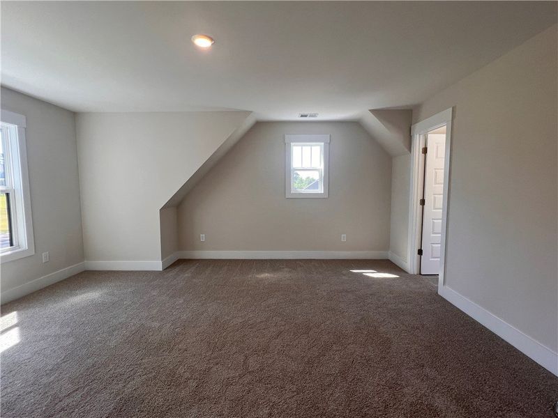 This spacious bedroom offers ample natural light a